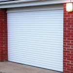 Classic white roller garage door that matches the building&#39;s façade